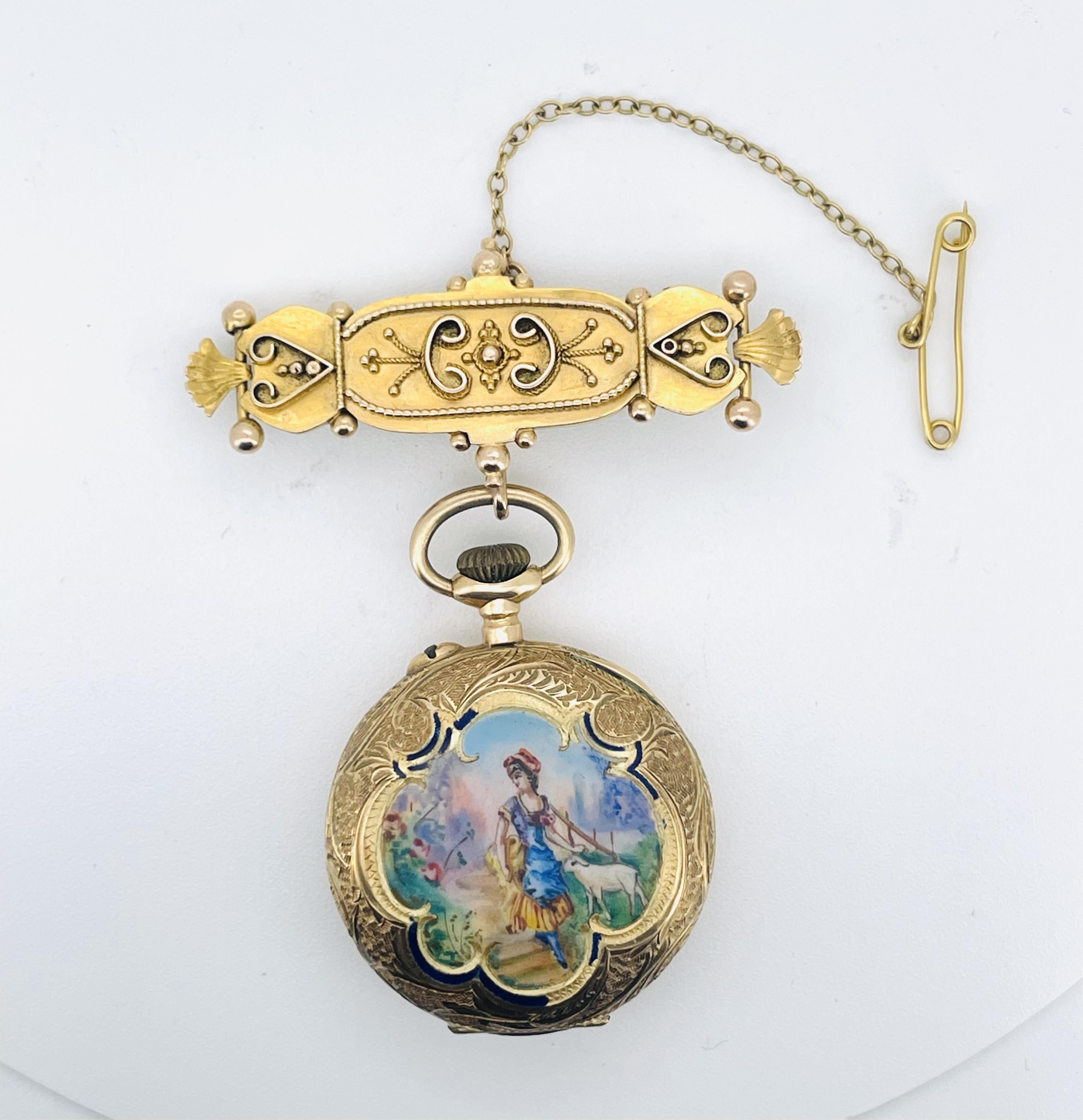 A lady's gold and Swiss enamel fob watch, circa 1907, the cream dial with gold enamel decoration and Arabic numeral indicators, the case with scrolled decoration, the reverse depicting a woman and lamb in a pastoral scen